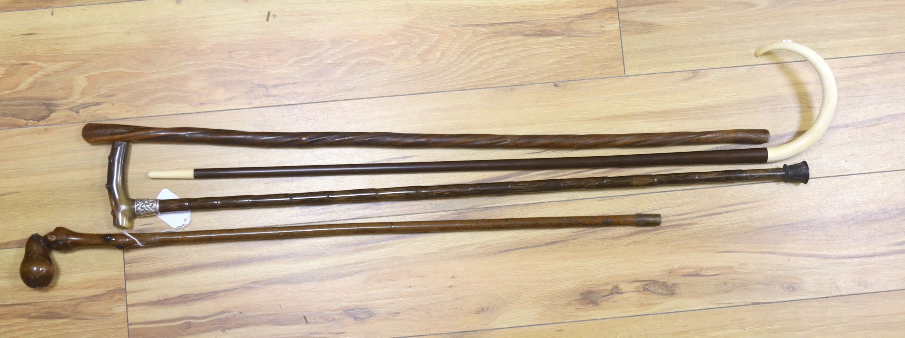 Four walking sticks, one horn and silver mounted